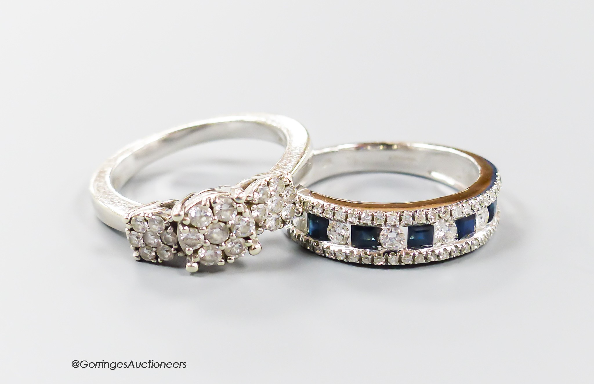 A modern 9ct white gold and triple diamond cluster set dress ring, size I/J and a similar sapphire and diamond set half hoop ring, size K, gross 6.5 grams.